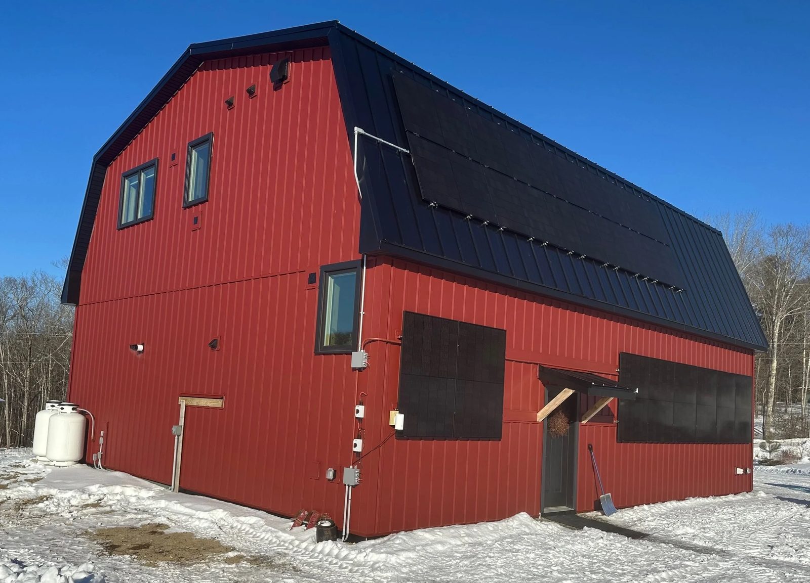 These are the building-mounted panels, both on the gambrel roof and on the side of the building. The propane tanks are for the radiant slab hydronic heating system for the garage and entry foyer. Not shown are three heat pumps on the other side of the building.