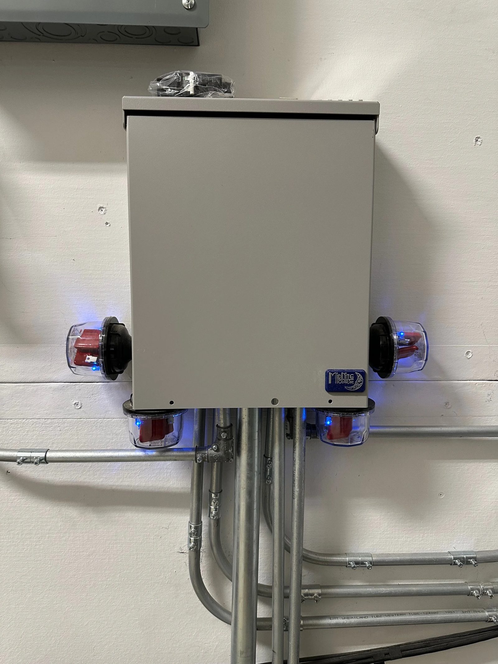 First combiner box with conduit and SPDs shown. Big conduit contains wires for 4 ground mount strings. Pic taken before I added another combiner box that looks like a sub panel to this one, for the 5th and 6th strings added in 2025.